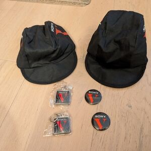 SONY Memorabilia: 2 Sony Black and Red Caps, 63 Key Chains And 25 Pins